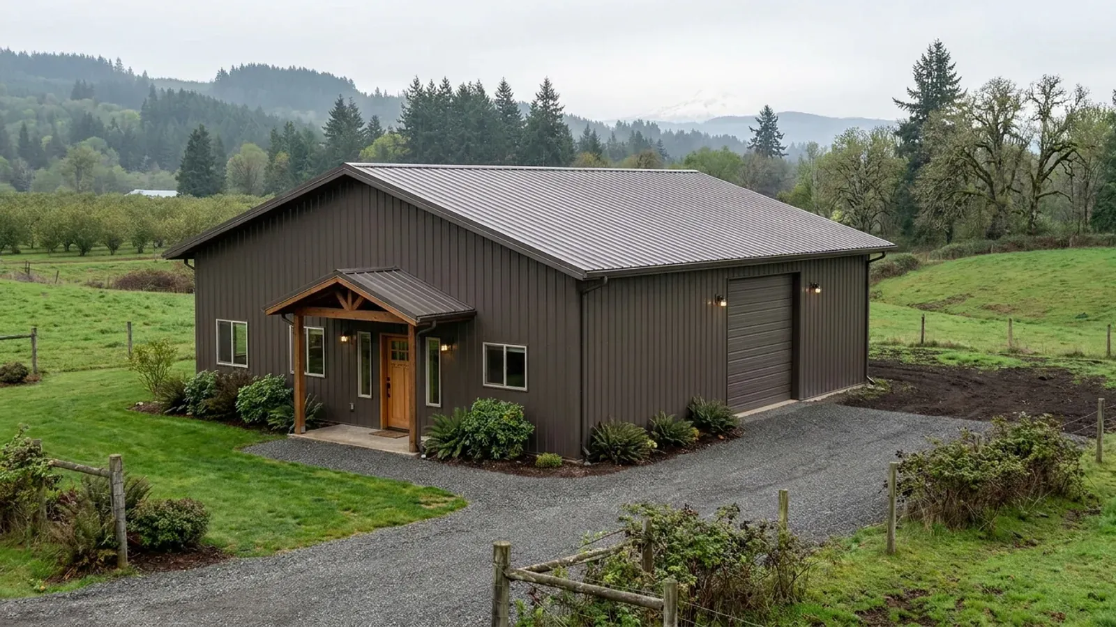 A completed 40x60 barndominium showing a residential entry on one end and a wide shop door on the other under one continuous roof.